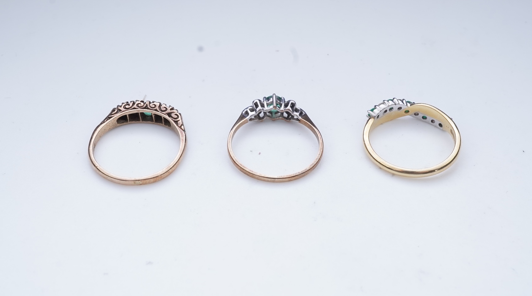 Three emerald and diamond rings